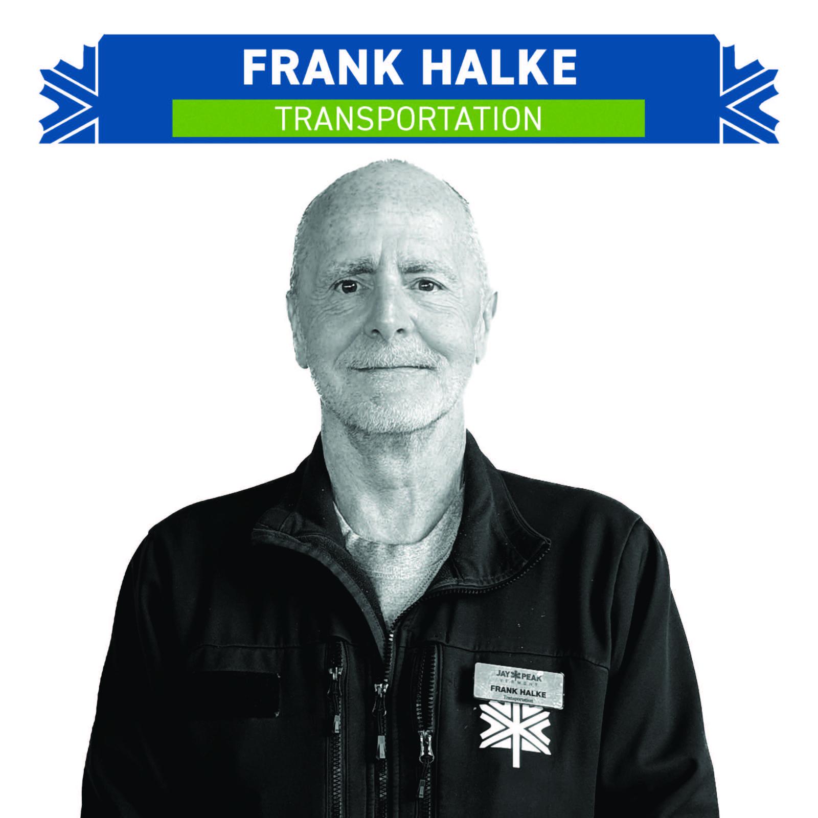 Black and white portrait of a smiling person wearing a dark jacket.